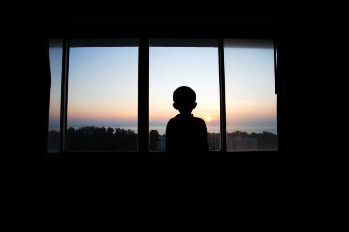 Boy,Silhouette,Standing,And,Watching,The,Morning,Sun,Rise,In
