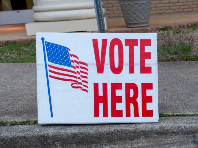 Elections,Polling,Place,Sign,Displaying,The,Words,"vote,Here",And