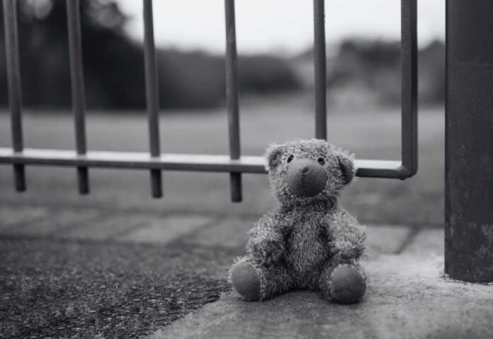 Black,And,White,Lost,Teddy,Bear,Sitting,Next,To,Metal