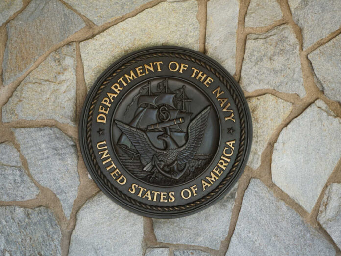 Bronze seal of the Department of the Navy mounted on a stone wall