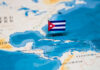 OUTRAGE as Cuba Seeks Exile Investments A small Cuban flag placed on a map highlighting Cuba in the Caribbean