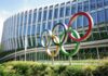 Colorful Olympic rings displayed in front of a modern building