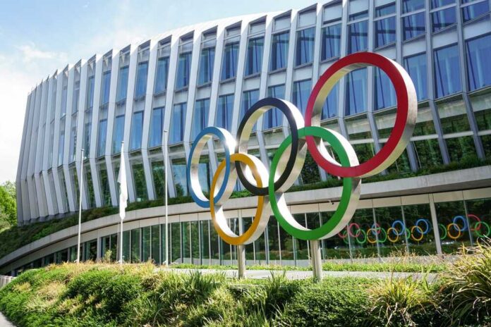 Colorful Olympic rings displayed in front of a modern building