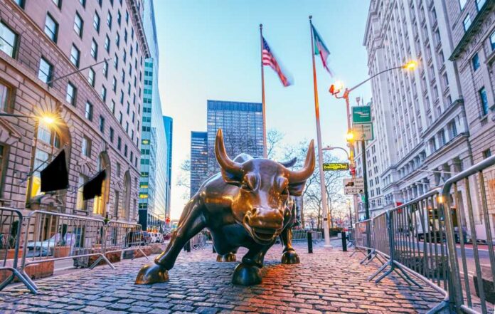Bronze charging bull sculpture in a city street