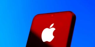 Close-up of a smartphone with the Apple logo against a red and blue background