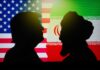 Silhouettes of two figures against the backgrounds of the American and Iranian flags