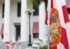 Florida state flag in front of a government building