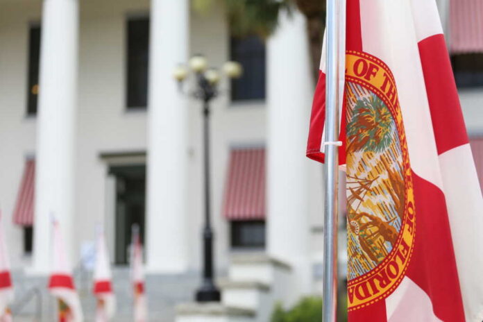 Florida state flag in front of a government building