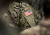 Close-up of a soldiers uniform featuring an American flag patch