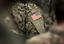 Close-up of a soldiers uniform featuring an American flag patch
