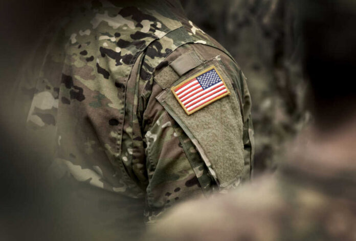 Close-up of a soldiers uniform featuring an American flag patch