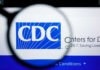 Magnifying glass focusing on the CDC logo on a computer screen