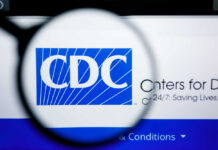 Magnifying glass focusing on the CDC logo on a computer screen