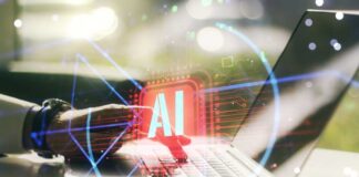 A hand interacting with a laptop displaying an AI symbol