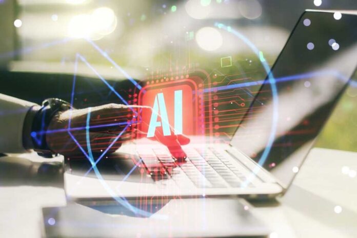 A hand interacting with a laptop displaying an AI symbol