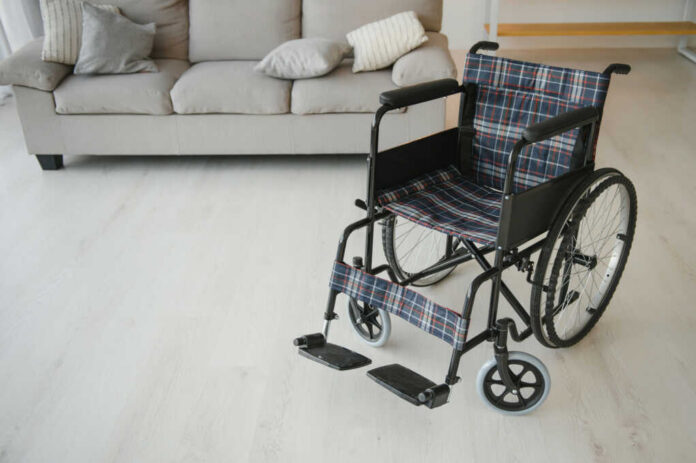 shutterstock_2172971943.jpg A wheelchair with plaid fabric in a living room setting