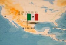 Map of North America with a flag of Mexico pinned on it