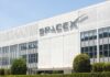 Exterior view of the SpaceX building with a prominent logo