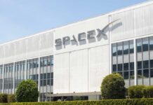Exterior view of the SpaceX building with a prominent logo