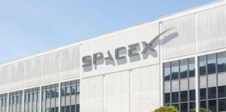 Exterior view of the SpaceX building with a prominent logo