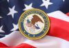 Department of Justice seal on an American flag background