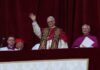Pope waving from a balcony during a public address