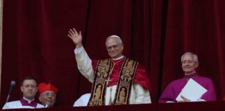 Pope waving from a balcony during a public address