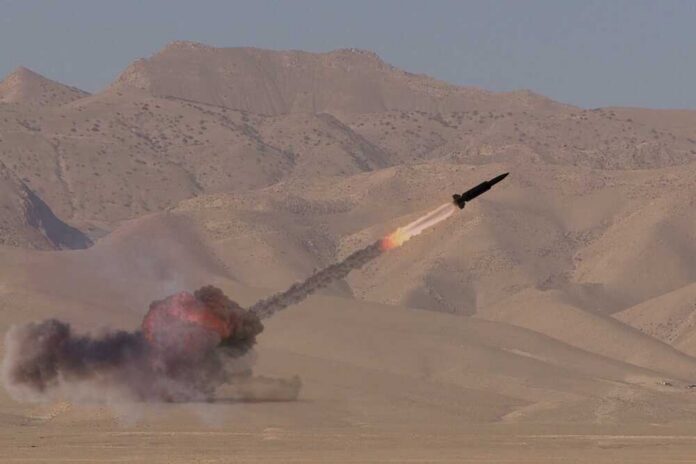 A missile launching into the sky with smoke and flames in a desert setting