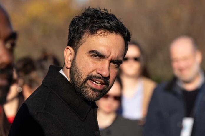 shutterstock_2706098681.jpg A man speaking passionately at an outdoor event with an engaged audience in the background