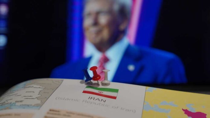 Map of Iran with push pins and a blurred figure in the background