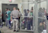 A group of individuals in a detention area with a security officer present