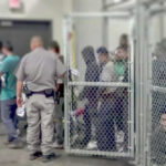 A group of individuals in a detention area with a security officer present