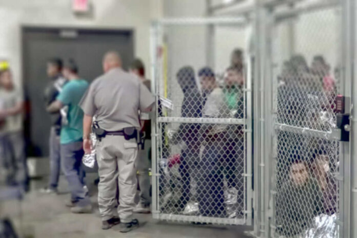 shutterstock1229072188jpg A group of individuals in a detention area with a security officer present