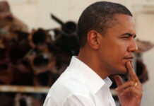 Profile view of a man in a white shirt with a thoughtful expression