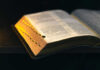 Shocking Debate: Is Morality Without God Possible? An open dictionary resting on a dark surface, showcasing its pages