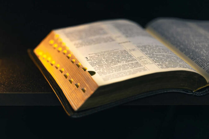 shutterstock2525231561-1jpg-1 An open dictionary resting on a dark surface, showcasing its pages