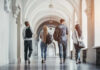 Group of students walking together in a university hallway