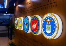 Record $1.15T Defense Bill Sparks Massive Debate! Display of military seals representing various branches of the U.S. Department of Defense