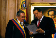 Shocking Indictment: Cuban Dictator Faces U.S. Justice Two officials examine a framed document during a ceremony