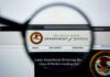 Close-up view of the Department of Justice website through a magnifying glass