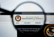 Top Prosecutor’s SHOCKING Secret Document Theft! Close-up view of the Department of Justice website through a magnifying glass