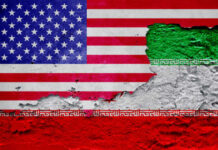 A textured wall featuring the flags of the USA and Iran