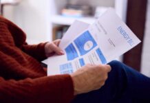 Electric Bills: The New Political Battlefield Person reviewing an energy bill with detailed information