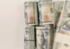 Stacks of hundred dollar bills arranged neatly