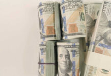 Stacks of hundred dollar bills arranged neatly