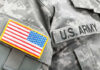 Bribery Scandal Unfolds – Army Employee Involved?! Close-up of a U.S. Army uniform with an American flag patch