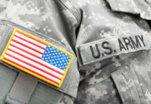 Bribery Scandal Unfolds – Army Employee Involved?! Close-up of a U.S. Army uniform with an American flag patch