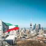 Iranian Guards Caught In Kuwait: Shocking Escalation Kuwait flag waving over a city skyline with modern buildings