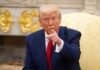 TRUMP’S Iran Bombshell—Peace Deal Near? A man in a blue suit and red tie pointing while seated