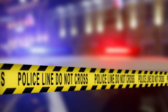 Yellow police tape reading 'DO NOT CROSS' at a crime scene